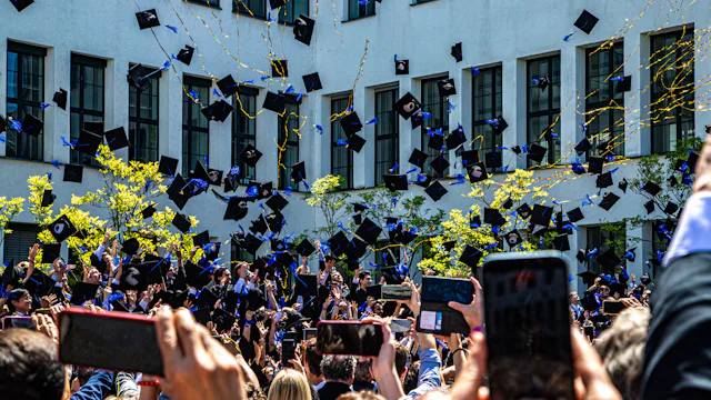 Graduates throwing caps into the air